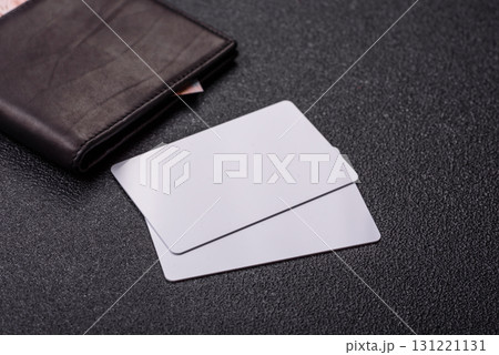 The white plastic card as a symbol of cashless payments on the background of cash paper money of Brazil 131221131