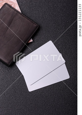 The white plastic card as a symbol of cashless payments on the background of cash paper money of Brazil 131221133