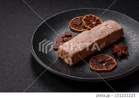 Nougat or white caramel with hazelnuts and pistachios and citrus pieces. White nougat with nuts Nougat or white caramel with hazelnuts and pistachios and citrus pieces. White nougat with nuts 131221225