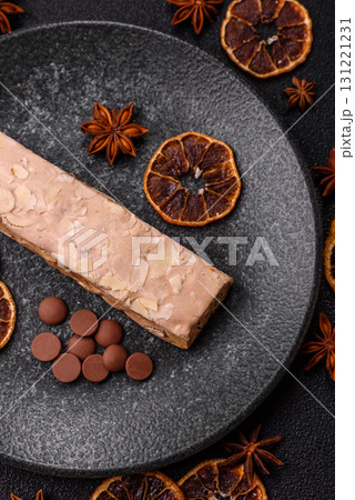 Nougat or white caramel with hazelnuts and pistachios and citrus pieces. White nougat with nuts 131221231