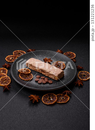 Nougat or white caramel with hazelnuts and pistachios and citrus pieces. White nougat with nuts Nougat or white caramel with hazelnuts and pistachios and citrus pieces. White nougat with nuts 131221236