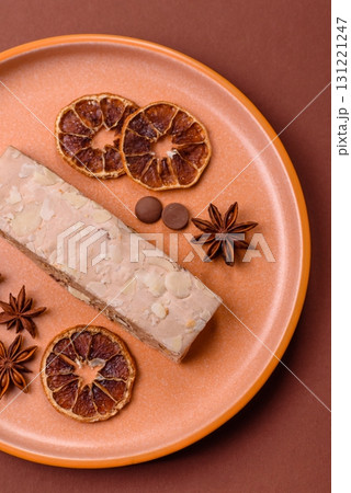 Nougat or white caramel with hazelnuts and pistachios and citrus pieces. White nougat with nuts Nougat or white caramel with hazelnuts and pistachios and citrus pieces. White nougat with nuts 131221247