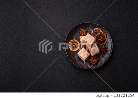 Nougat or white caramel with hazelnuts and pistachios and citrus pieces. White nougat with nuts 131221254