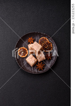 Nougat or white caramel with hazelnuts and pistachios and citrus pieces. White nougat with nuts Nougat or white caramel with hazelnuts and pistachios and citrus pieces. White nougat with nuts 131221255