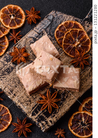 Nougat or white caramel with hazelnuts and pistachios and citrus pieces. White nougat with nuts 131221280
