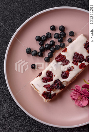 Nougat or white caramel with hazelnuts and pistachios and citrus pieces. White nougat with nuts 131221295