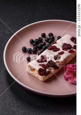 Nougat or white caramel with hazelnuts and pistachios and citrus pieces. White nougat with nuts 131221296
