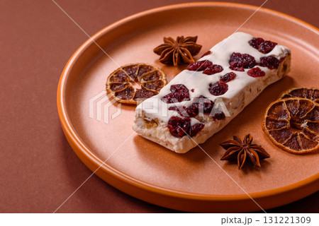 Nougat or white caramel with hazelnuts and pistachios and citrus pieces. White nougat with nuts 131221309