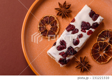 Nougat or white caramel with hazelnuts and pistachios and citrus pieces. White nougat with nuts 131221310