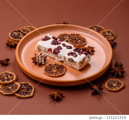 Nougat or white caramel with hazelnuts and pistachios and citrus pieces. White nougat with nuts Nougat or white caramel with hazelnuts and pistachios and citrus pieces. White nougat with nuts 131221319