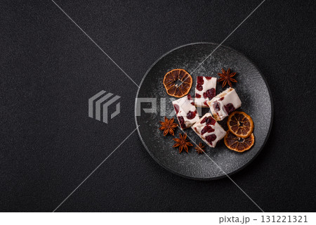 Nougat or white caramel with hazelnuts and pistachios and citrus pieces. White nougat with nuts 131221321