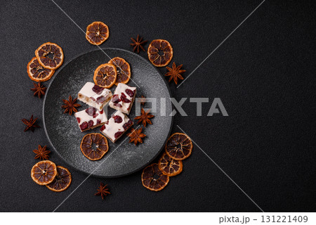 Nougat or white caramel with hazelnuts and pistachios and citrus pieces. White nougat with nuts 131221409