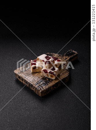 Nougat or white caramel with hazelnuts and pistachios and citrus pieces. White nougat with nuts 131221415