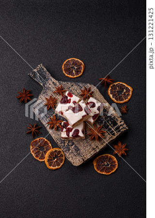 Nougat or white caramel with hazelnuts and pistachios and citrus pieces. White nougat with nuts Nougat or white caramel with hazelnuts and pistachios and citrus pieces. White nougat with nuts 131221425