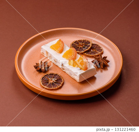 Nougat or white caramel with hazelnuts and pistachios and citrus pieces. White nougat with nuts Nougat or white caramel with hazelnuts and pistachios and citrus pieces. White nougat with nuts 131221460