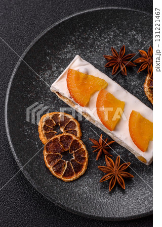 Nougat or white caramel with hazelnuts and pistachios and citrus pieces. White nougat with nuts 131221467