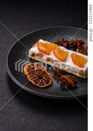 Nougat or white caramel with hazelnuts and pistachios and citrus pieces. White nougat with nuts Nougat or white caramel with hazelnuts and pistachios and citrus pieces. White nougat with nuts 131221468