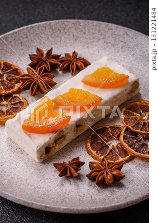 Nougat or white caramel with hazelnuts and pistachios and citrus pieces. White nougat with nuts 131221484