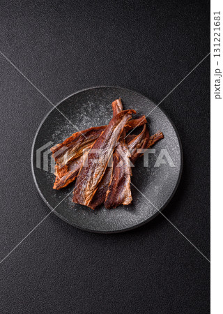 Dried salted fish as snacks or jerky, seafood as slices. Dried seafood snacks Dried salted fish as snacks or jerky, seafood as slices. Dried seafood snacks 131221681