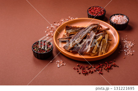 Dried salted fish as snacks or jerky, seafood as slices. Dried seafood snacks Dried salted fish as snacks or jerky, seafood as slices. Dried seafood snacks 131221695