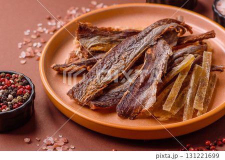 Dried salted fish as snacks or jerky, seafood as slices. Dried seafood snacks 131221699