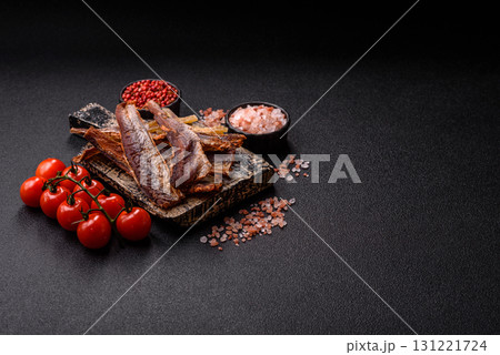 Dried salted fish as snacks or jerky, seafood as slices. Dried seafood snacks 131221724