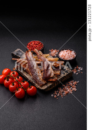 Dried salted fish as snacks or jerky, seafood as slices. Dried seafood snacks 131221728