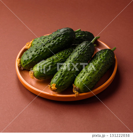 Fresh raw whole cucumbers, an ingredient for preparing salads and vegetarian dishes. Green fresh cucumbers 131222038