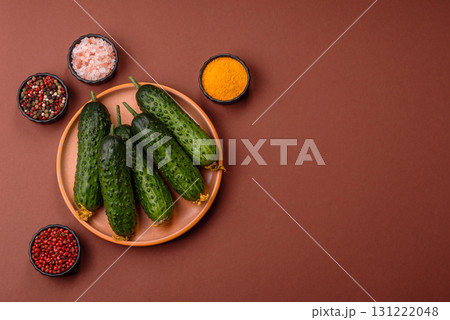 Fresh raw whole cucumbers, an ingredient for preparing salads and vegetarian dishes. Green fresh cucumbers Fresh raw whole cucumbers, an ingredient for preparing salads and vegetarian dishes. Green fresh cucumbers 131222048