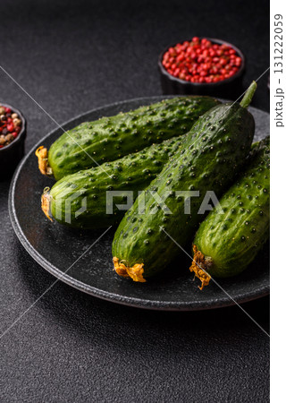 Fresh raw whole cucumbers, an ingredient for preparing salads and vegetarian dishes. Green fresh cucumbers Fresh raw whole cucumbers, an ingredient for preparing salads and vegetarian dishes. Green fresh cucumbers 131222059