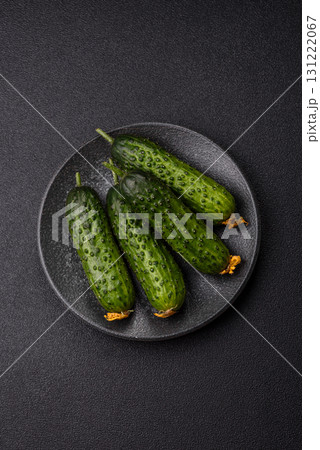 Fresh raw whole cucumbers, an ingredient for preparing salads and vegetarian dishes. Green fresh cucumbers Fresh raw whole cucumbers, an ingredient for preparing salads and vegetarian dishes. Green fresh cucumbers 131222067