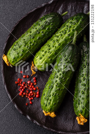 Fresh raw whole cucumbers, an ingredient for preparing salads and vegetarian dishes. Green fresh cucumbers 131222198