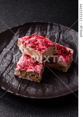 Nougat or white caramel with hazelnuts and strawberry pieces. White nougat 131222344