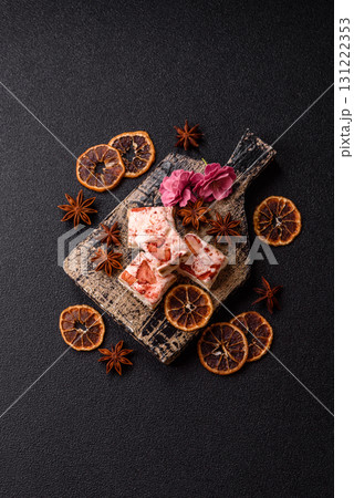 Nougat or white caramel with hazelnuts and strawberry pieces. White nougat 131222353