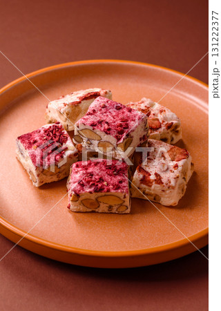Nougat or white caramel with hazelnuts and strawberry pieces. White nougat Nougat or white caramel with hazelnuts and strawberry pieces. White nougat 131222377