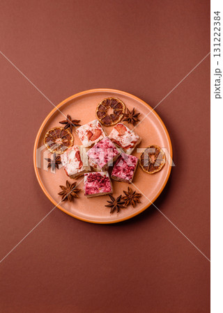 Nougat or white caramel with hazelnuts and strawberry pieces. White nougat Nougat or white caramel with hazelnuts and strawberry pieces. White nougat 131222384