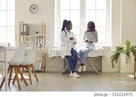 Doctor and Patient Conversing in Hospital Setting Doctor and Patient Conversing in Hospital Setting 131222475