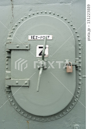 Heavy-duty metal hatch on a military vessel with secure locking system 131223889