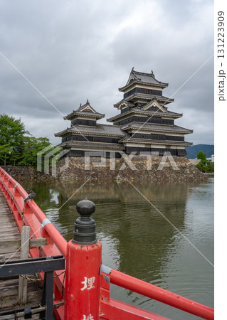 Red bridge leading to majestic Matsumoto Castle in Japan 131223909