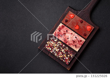 Bar sweet craft artisan chocolate with dried fruits made at home. Craft chocolate Bar sweet craft artisan chocolate with dried fruits made at home. Craft chocolate 131225026