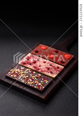 Bar sweet craft artisan chocolate with dried fruits made at home. Craft chocolate 131225028