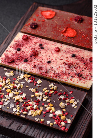 Bar sweet craft artisan chocolate with dried fruits made at home. Craft chocolate Bar sweet craft artisan chocolate with dried fruits made at home. Craft chocolate 131225032