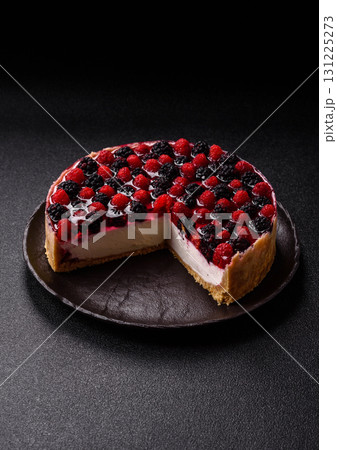 Pie, cheesecake with raspberries and blackberries, mascarpone cheese. Piece of cheesecake 131225273