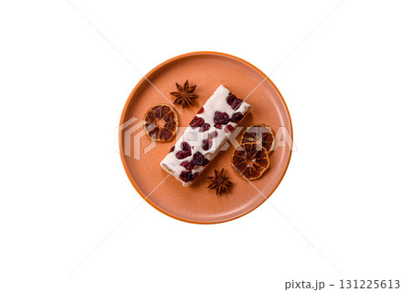 Nougat or white caramel with hazelnuts and pistachios and citrus pieces. White nougat with nuts Nougat or white caramel with hazelnuts and pistachios and citrus pieces. White nougat with nuts 131225613