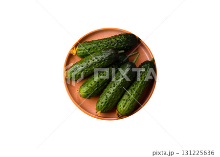 Fresh raw whole cucumbers, an ingredient for preparing salads and vegetarian dishes. Green fresh cucumbers Fresh raw whole cucumbers, an ingredient for preparing salads and vegetarian dishes. Green fresh cucumbers 131225636