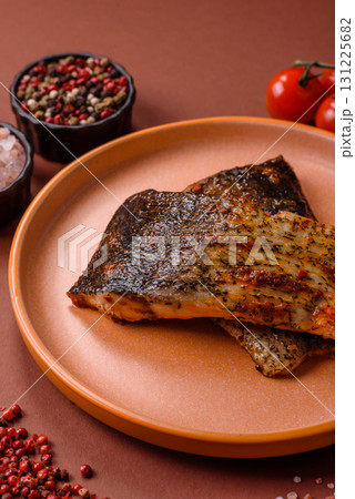 Food, seafood, grilled fish fillet with lemon, salt and spices. Grilled fish fillet Food, seafood, grilled fish fillet with lemon, salt and spices. Grilled fish fillet 131225682