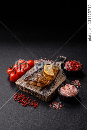 Food, seafood, grilled fish fillet with lemon, salt and spices. Grilled fish fillet Food, seafood, grilled fish fillet with lemon, salt and spices. Grilled fish fillet 131225710