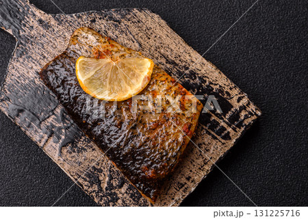 Food, seafood, grilled fish fillet with lemon, salt and spices. Grilled fish fillet Food, seafood, grilled fish fillet with lemon, salt and spices. Grilled fish fillet 131225716