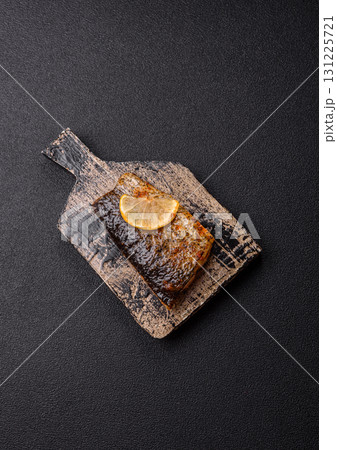 Food, seafood, grilled fish fillet with lemon, salt and spices. Grilled fish fillet Food, seafood, grilled fish fillet with lemon, salt and spices. Grilled fish fillet 131225721