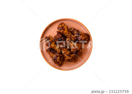Grilled or barbecued chicken wings with teriyaki sauce, spices and sesame seeds. Teriyaki chicken Grilled or barbecued chicken wings with teriyaki sauce, spices and sesame seeds. Teriyaki chicken 131225759